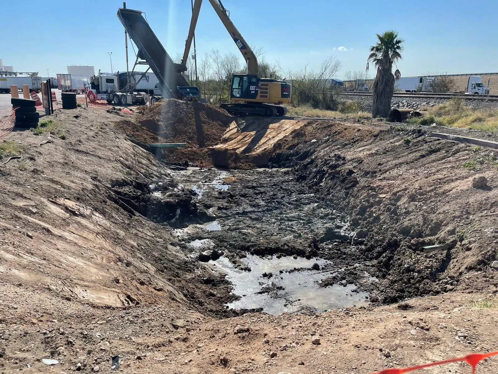 Excavator digging a trench for environmental construction work